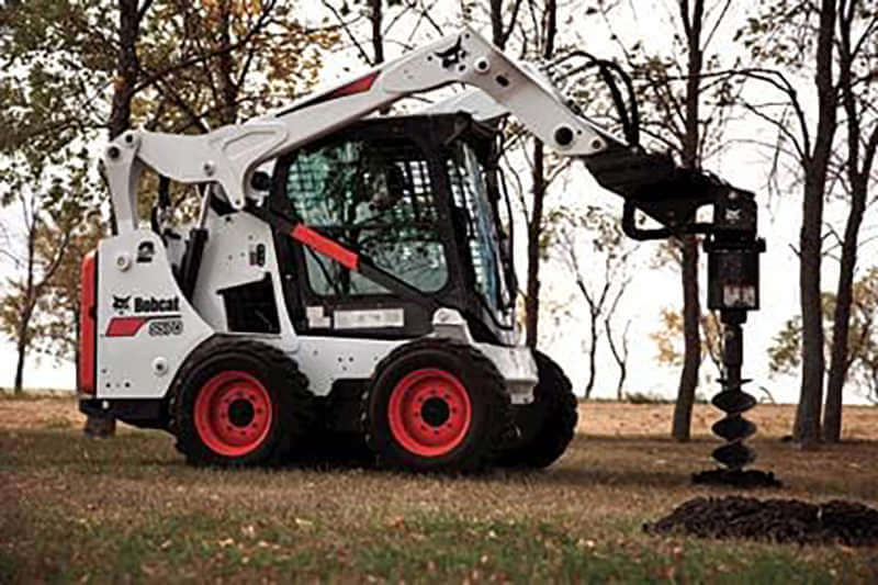 Skid steer auger attachments and auger bits