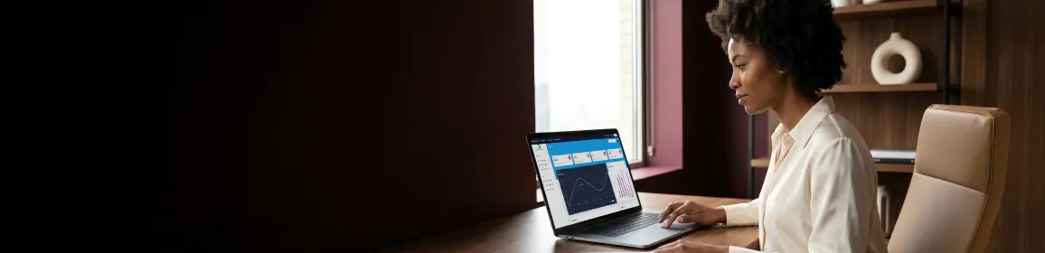SaaS product lead reviewing user flow diagrams and analytics on laptop at desk with natural window light