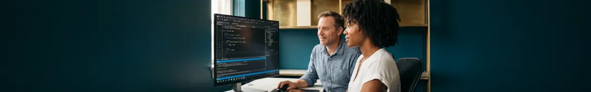 Development team reviewing complex legacy .NET codebase on large monitors with tired focused expressions in dim office environment Development team reviewing complex legacy .NET codebase on large monitors with tired focused expressions in dim office environment