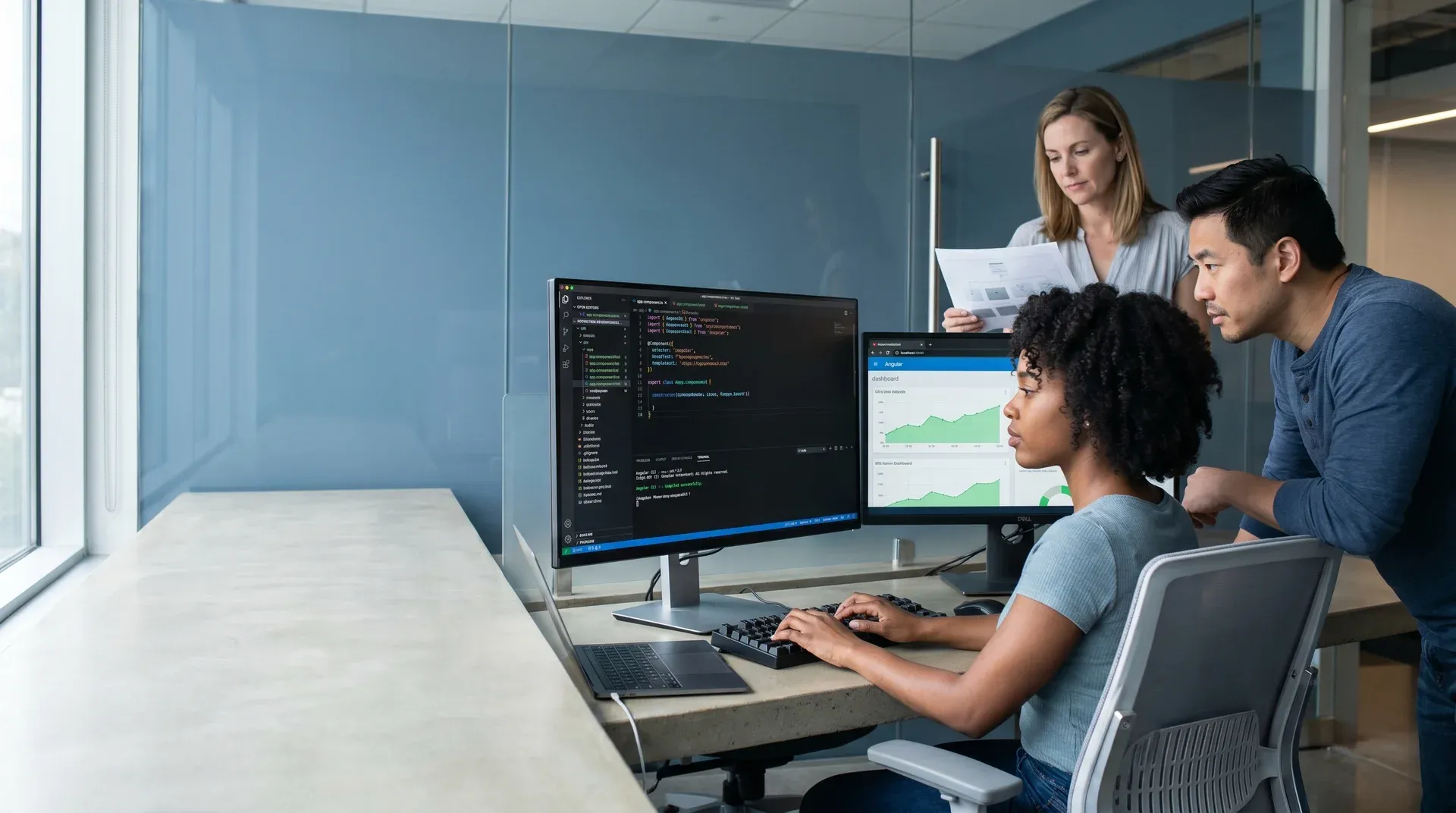 Angular development engineers building enterprise application at multi-monitor workstations Angular development engineers building enterprise application at multi-monitor workstations