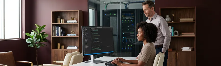 Laravel backend development team at workstations managing enterprise server infrastructure, warm desk lamp light, side angle Laravel backend development team at workstations managing enterprise server infrastructure, warm desk lamp light, side angle