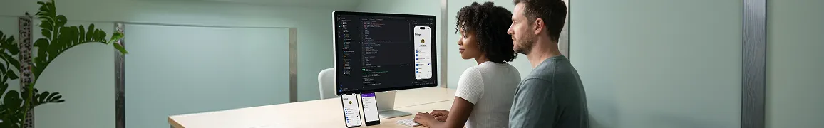 React Native engineering team reviewing app builds on iPhone and Android phones simultaneously React Native engineering team reviewing app builds on iPhone and Android phones simultaneously