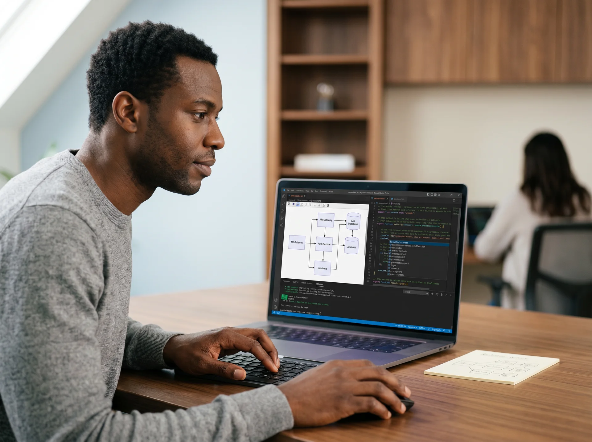 Engineer reviewing architecture diagram in VS Code with split-screen terminal Engineer reviewing architecture diagram in VS Code with split-screen terminal