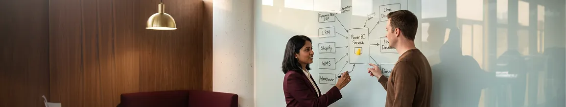 Two integration architects mapping Power BI data source connections on a whiteboard Two integration architects mapping Power BI data source connections on a whiteboard