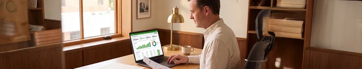 Finance professional at clean tidy desk reviewing healthy QuickBooks Online dashboard with green Synced transactions, calm satisfied expression, warm late-afternoon light Finance professional at clean tidy desk reviewing healthy QuickBooks Online dashboard with green Synced transactions, calm satisfied expression, warm late-afternoon light