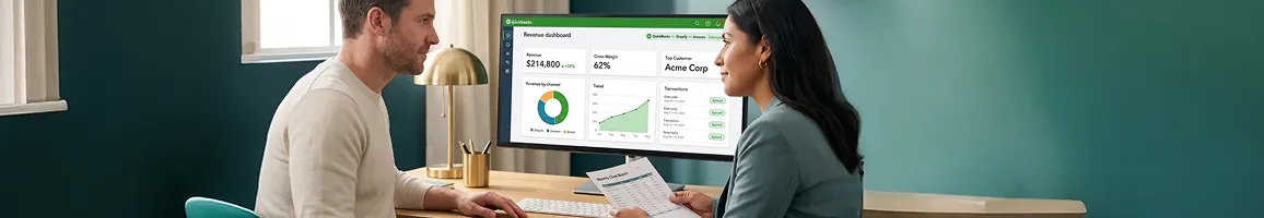 Two team members reviewing integrated QuickBooks and eCommerce financial report together, side angle, natural light Two team members reviewing integrated QuickBooks and eCommerce financial report together, side angle, natural light