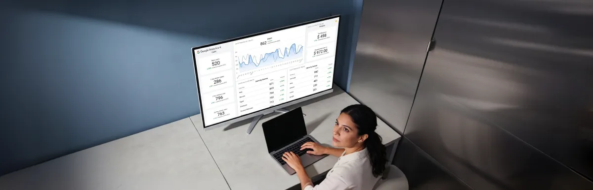 Marketing analyst reviewing one unified attribution dashboard with channels aligned and KPIs climbing, calm analytical focus Marketing analyst reviewing one unified attribution dashboard with channels aligned and KPIs climbing, calm analytical focus